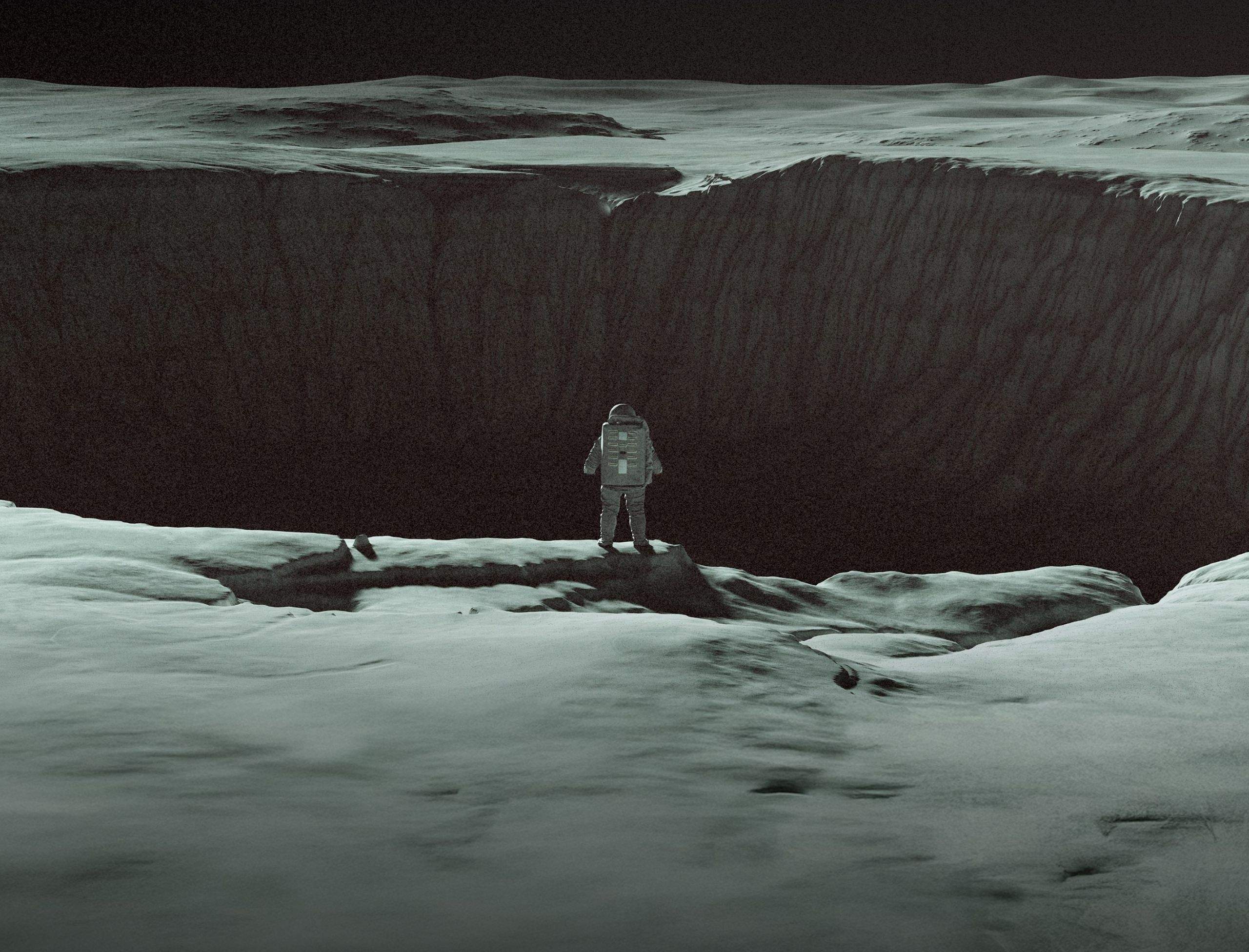 An astronaut in front of a large crater